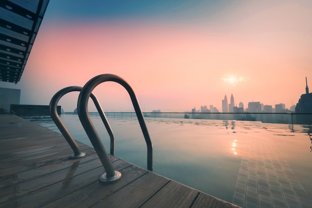 Stadtbild der Skyline von Kuala Lumpur mit Schwimmbad auf dem Dach des Hotels bei Sonnenaufgang in Malaysia.