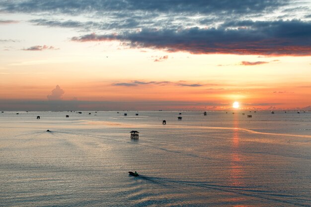 Standpunkt bei Sonnenaufgang des schönen Meeres mit Holzhäusern an der Bucht von Bang Tabun