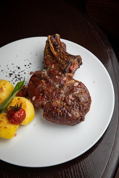 Steak mit Kartoffeln und Kirschen auf einem Teller