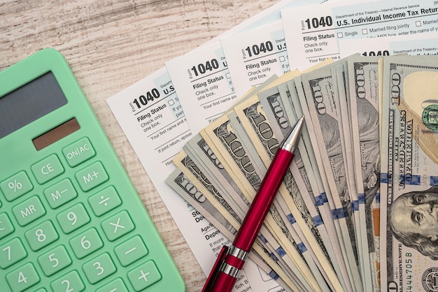Steuer- und Buchhaltungskonzept, 1040-Form-Stiftrechner und Dollarnoten