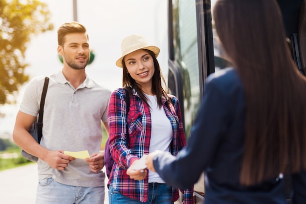 Stewardess Greets Couple Taking Bus Guter Service.