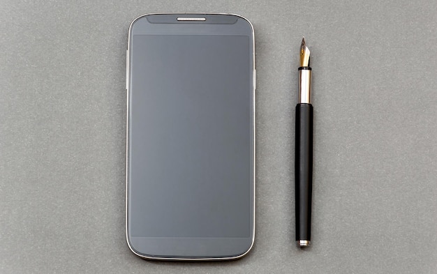 Stift mit Smartphone auf dem grauen Hintergrund Draufsicht