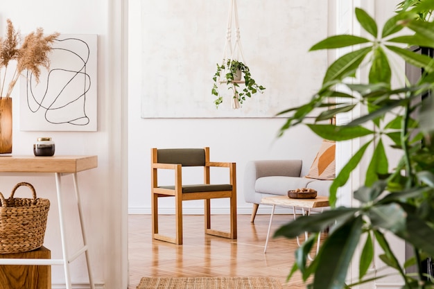 Stilvolle Komposition aus kreativer, geräumiger Wohnung mit grauem Sofa, Couchtisch, Pflanzen, Teppich und schönen Accessoires. Weiße Wände und Parkettboden.