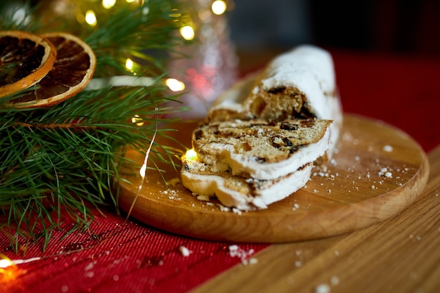 Stollen deutsches weihnachtsbrot, weihnachtsstollen auf holzhintergrund, traditionelles festliches gebäckdessert.