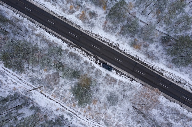 Straße durch den Winterwald Draufsicht Drohnenschießen