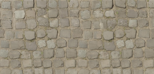 Straßenoberfläche aus quadratischen Steinen Kies Bürgersteig Detail von Kopfsteinpflaster in alter Straße Alt