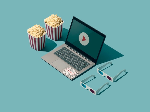 Foto streaming de filmes on-line e player de vídeo de cinema em uma tela de laptop óculos 3d e pipoca