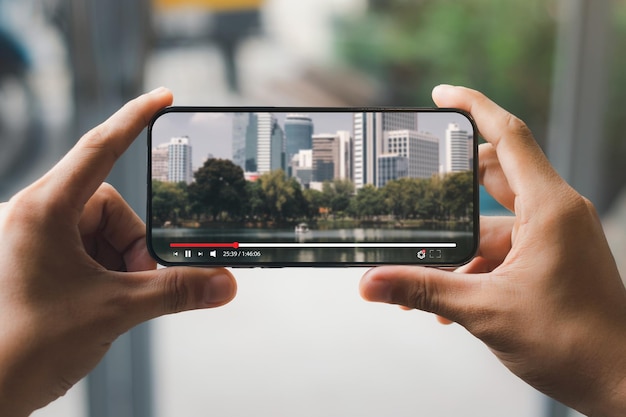 Streaming de películas en línea con teléfono inteligente Joven viendo una película