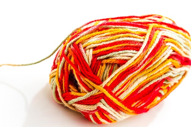 Stricken mit mehrfarbigem Garn mit Orange-, Rot- und Gelbtönen.