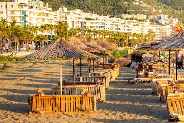 Strohschirme am Strand mit Hotels für Touristen im Hintergrund