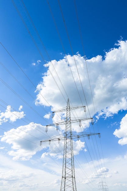 Strommast am blauen bewölkten Himmel Industriehochspannung