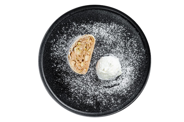 Foto strudel de manzana con azúcar en polvo de canela y helado de vainilla en un plato con fondo blanco aislado vista superior