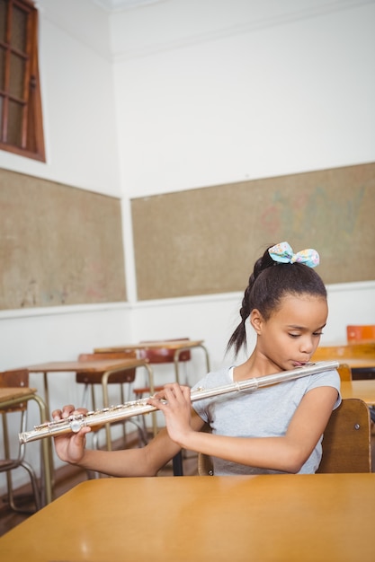 Student, der eine Flöte in der Klasse verwendet