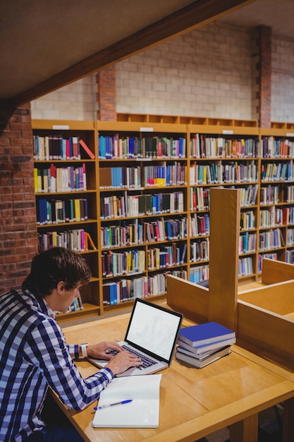 Student mit Laptop in der Bibliothek