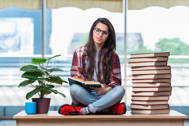 Student sitzt auf dem Schreibtisch mit Büchern