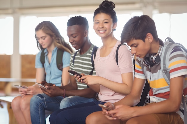 Studenten, die auf dem Campus ein Mobiltelefon benutzen