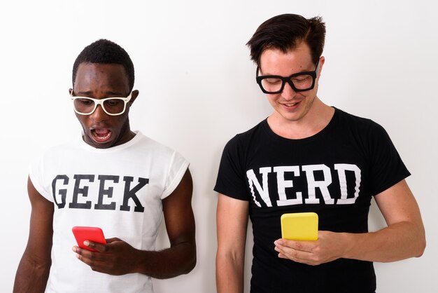 Foto studioaufnahme des jungen schockierten schwarzafrikaner-geek-mannes mit handy