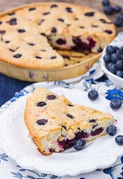 Stück süßer Blaubeerkuchen auf weißer Untertasse