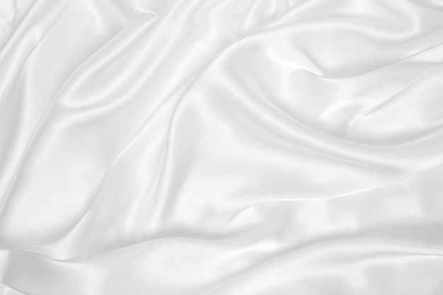 Suave y elegante textura de tela de seda blanca o satén de lujo que se puede utilizar como fondo de boda Diseño de fondo lujoso