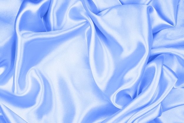 Suave seda azul elegante o textura satinada se puede utilizar como fondo abstracto, tela