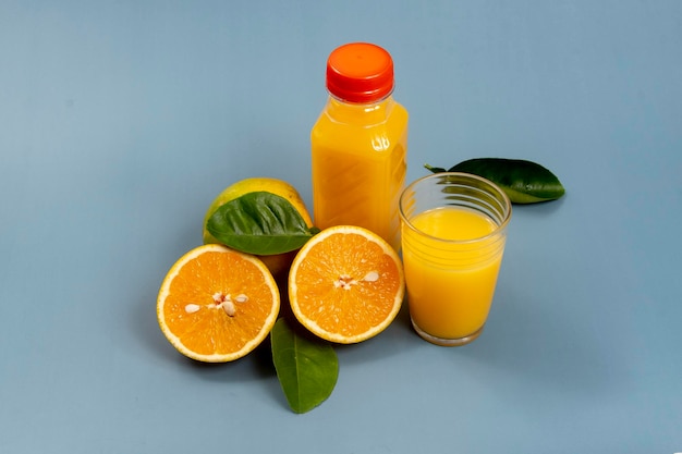 Suco de laranja natural no copo com garrafa ao lado