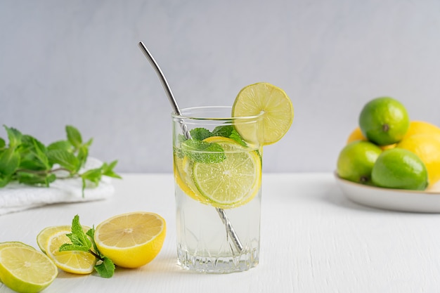 süße Limonade sommerliches Kaltgetränk aus sauer reifen Zitronen- und Limettenscheiben Wasser mit Kohlensäure und Minze