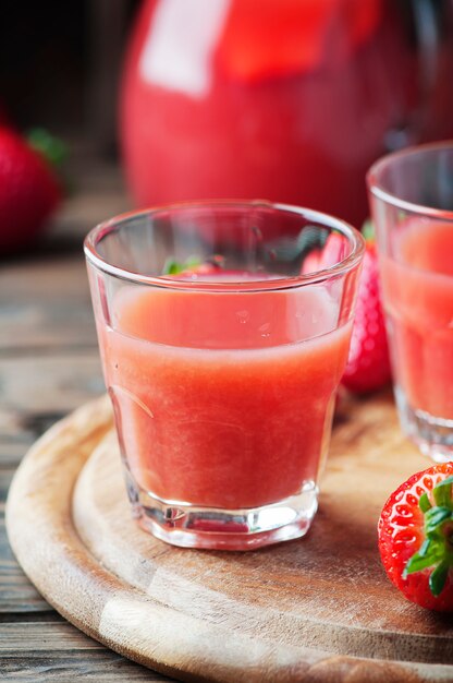 Süßer Erdbeersaft auf dem Holztisch