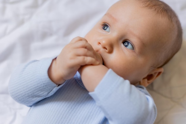 Süßer kleiner junge im blauen körper, der auf decke, karte, banner, gesundheit, platz für text legt