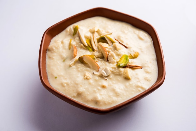 Süßer Rabdi oder Lachha Rabri oder Basundi, hergestellt aus reiner Milch, garniert mit Trockenfrüchten. Serviert in einer Schüssel über stimmungsvollem Hintergrund. Selektiver Fokus