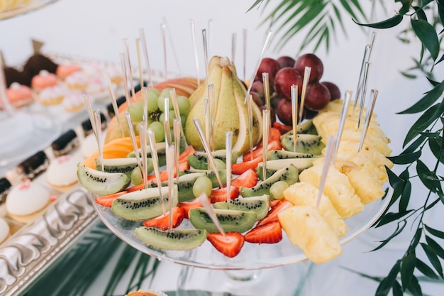 Süßes Buffet der schönen Hochzeit mit Dekor und Grün.