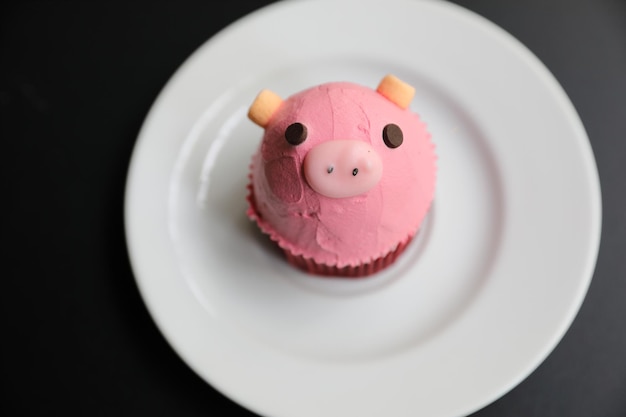 Süßes Schweinegesicht des ausgefallenen Cupcakes