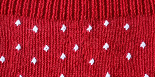 Foto suéter de lana de textura de color rojo con puntos blancos material de lana de punto natural de color rojizo oscuro