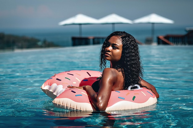 Summer StyleAfrican Woman On Pink Flamingo In Swimming Pool Water Beautiful Young Female