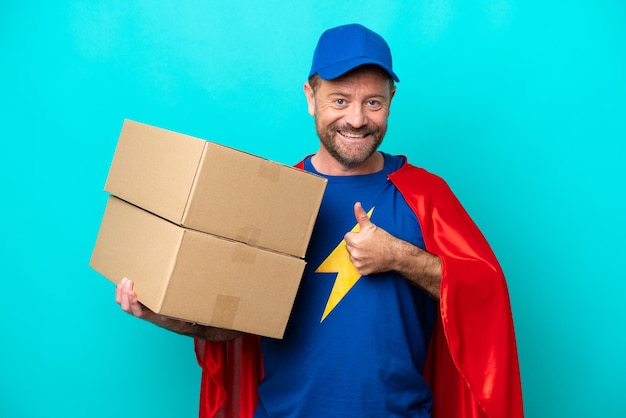 Super héroe repartidor aislado sobre fondo azul dando un pulgar hacia arriba gesto