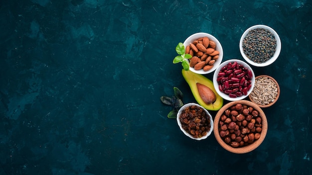 Superalimentos Alimentos saludables Nueces bayas frutas y legumbres Sobre un fondo de piedra negra Vista superior Espacio de copia libre