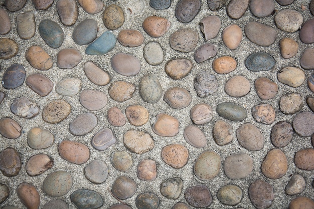 Superfície da parede de pedra com fundo de cimento