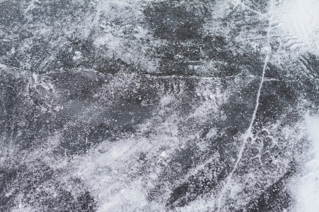 Superfície de isut Texutured do lago congelado com rachaduras.