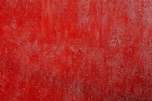 Superfície de metal enferrujada pintada de vermelho áspero, textura de alta resolução.