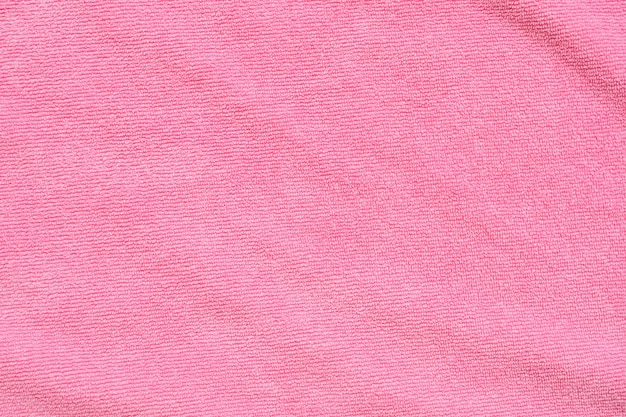 Foto superfície de textura de tecido de toalha rosa perto do fundo