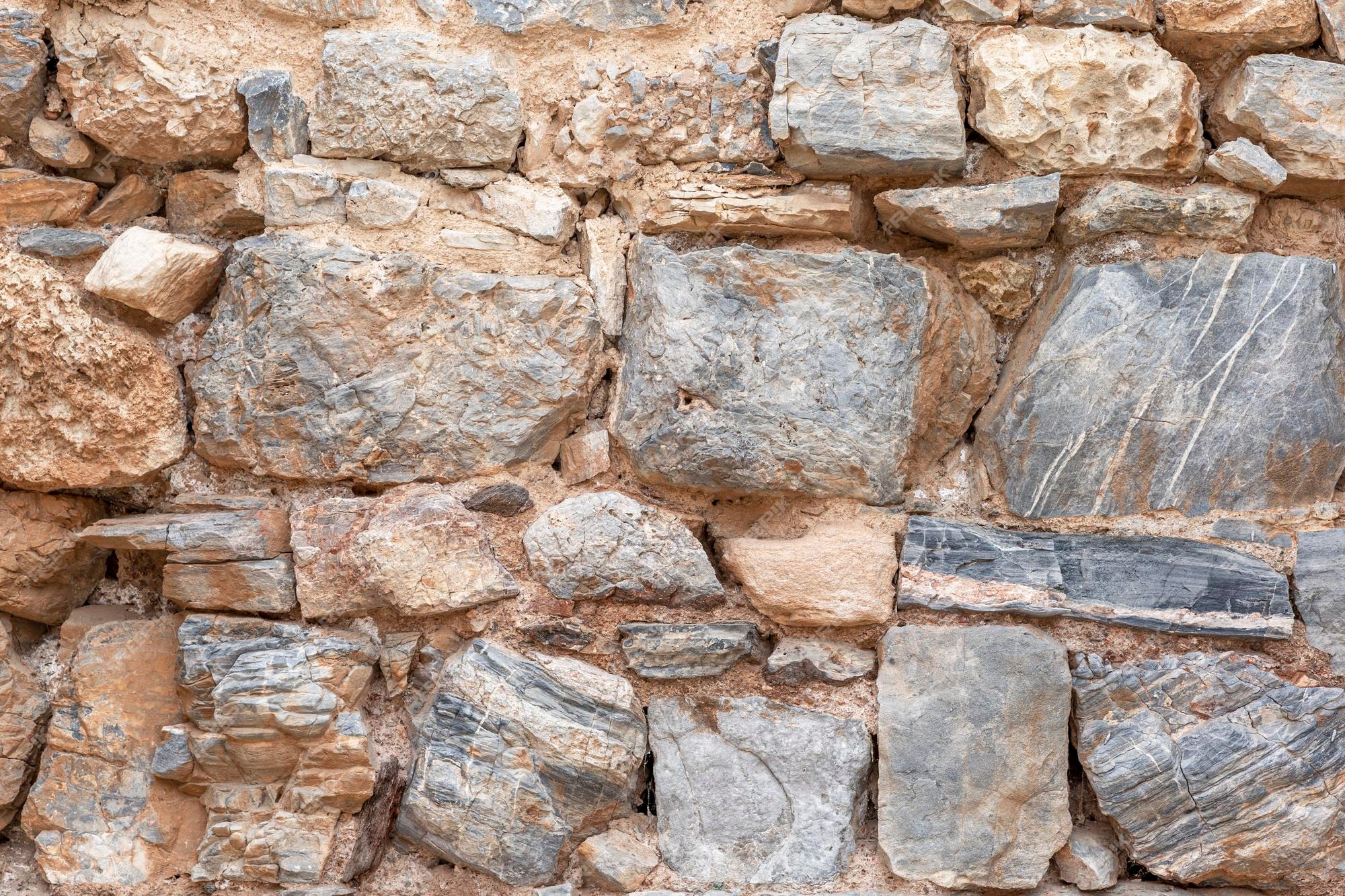 Superfície de um antigo muro de pedra materiais de construção naturais  antiguidade e história espaço de fundo para texto