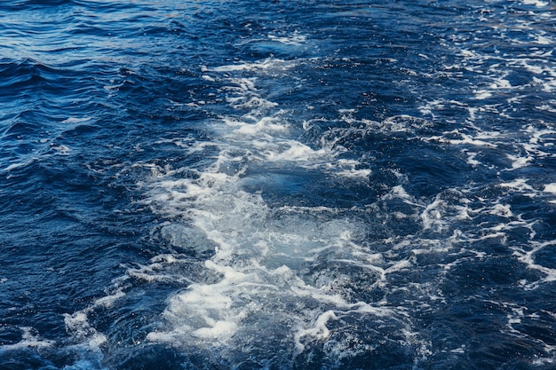 Superfície do mar azul com salpicos de ondas