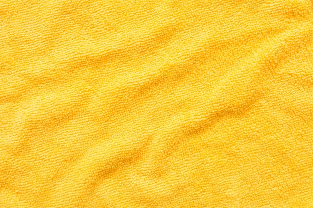 Superfície do pano de microfibra amarelo macro têxtil padrão de fundo