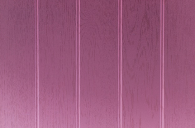 Superficie del fondo de textura de madera con color rosa.