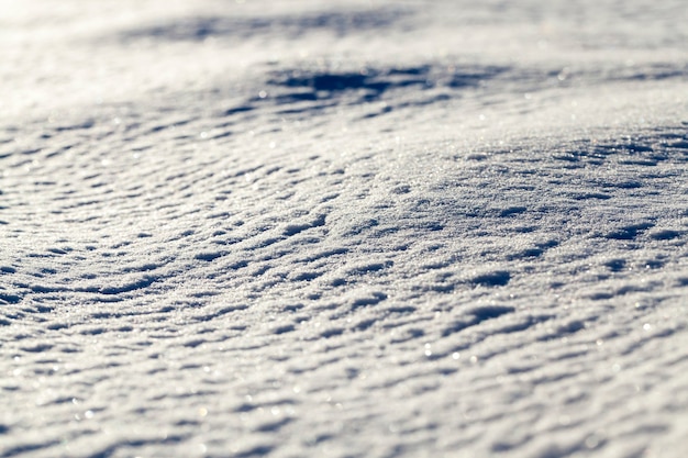 La superficie de la nieve en la temporada de invierno. La foto fue tomada en primer plano desde el costado, con poca profundidad de campo.
