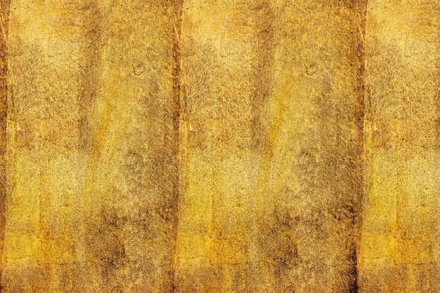 Superficie de pared de hormigón antiguo con textura abstracta de color dorado para el fondo