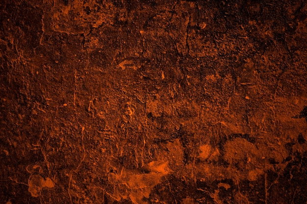 Superficie de pared de hormigón áspera dañada vieja pintada de color naranja para textura