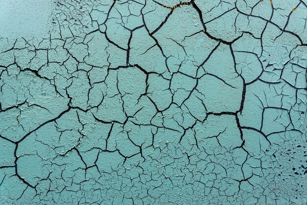 Superfície pintada rachada e danificada de um edifício ou parede Textura de fundo de pintura envelhecida Foto de alta qualidade