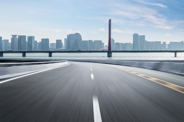 Superficie del piso de la carretera vacía con edificios emblemáticos de la ciudad moderna