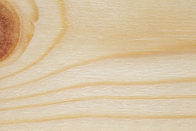 Foto superficie de tabla de madera en primer plano con rastro de parte del nudo de madera
