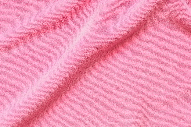 Foto la superficie de la textura de la toalla rosa es el fondo de primer plano